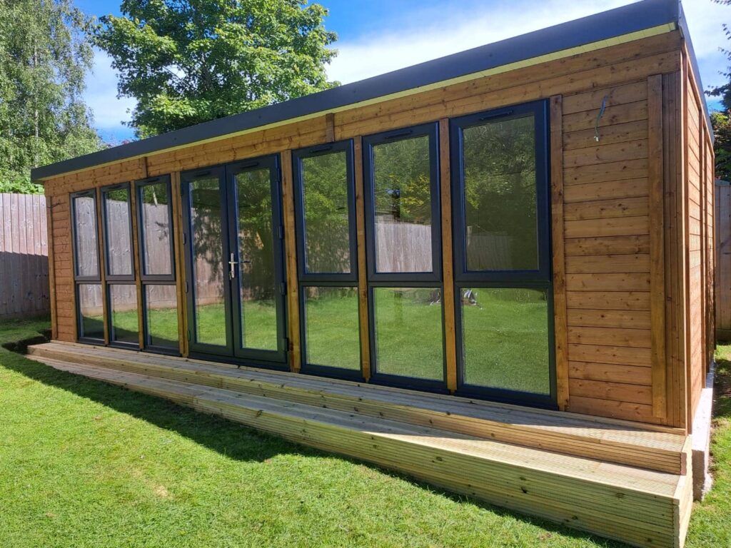 Garden shed featuring windows and a glass door for a modern touch.