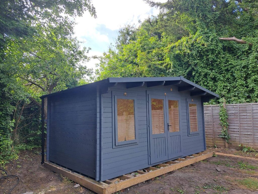 Garden cabin painted in a sleek grey finish for a contemporary look.