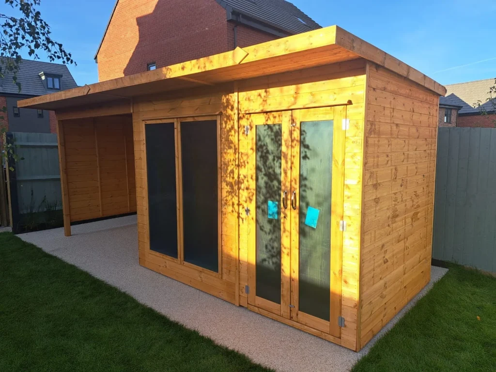 Wooden Log Cabin in Garden with sun shining on it